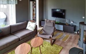 a living room with a couch and a tv at Beautiful Home In Sankt Anna With Kitchen in Sankt Anna