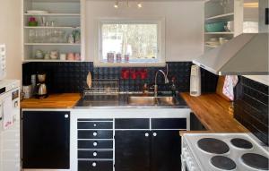 a kitchen with a sink and a counter top at Beautiful Home In Trans With Kitchen in Tranås