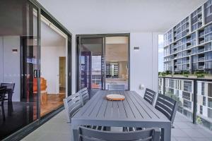 a dining room with a blue table and chairs at Regatta Hideaway - A Breezy Balcony Residence in Brisbane