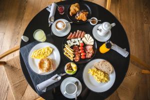 a black table with plates of breakfast food on it at SLS Buenos Aires Puerto Madero in Buenos Aires