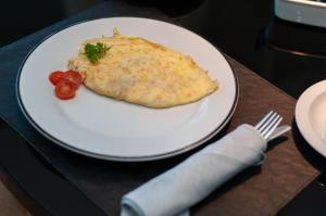a white plate with a piece of food on a table at SLS Buenos Aires Puerto Madero in Buenos Aires