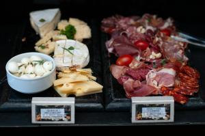 a tray of different types of food on a table at SLS Buenos Aires Puerto Madero in Buenos Aires