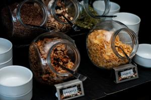 a bunch of food in glass containers on a table at SLS Buenos Aires Puerto Madero in Buenos Aires