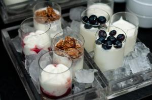 a tray with several desserts in glasses with ice and berries at SLS Buenos Aires Puerto Madero in Buenos Aires