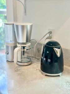 a blender sitting on a counter next to a mixer at Modern, Bright 2BR Casita in Vibrant Echo Park Silver Lake with Gourmet Kitchen and Unbeatable Proximity to LA Hotspots in Los Angeles