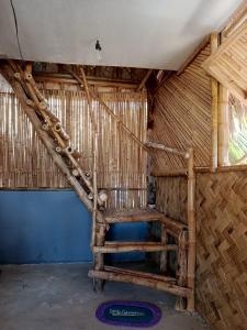 a room with a staircase in a straw hut at 8 Star Paradise in Locaroc