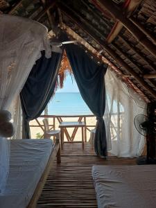 a room with beds and a view of the ocean at 8 Star Paradise in Locaroc