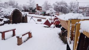 a yard covered in snow with a bulldozer at EUSKADI (Refugio de montaña) in Huinganco