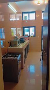 a kitchen with a stove and a counter top at Timba Miché04 in Cotonou