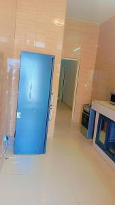 a blue door in the middle of a room at Timba Miché04 in Cotonou