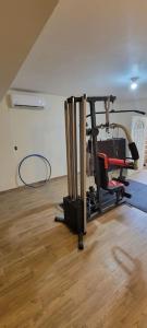a room with a gym with a chair on a wooden floor at Departamento Nuevo con clima,centrico,Parking #6 in Ciudad Valles