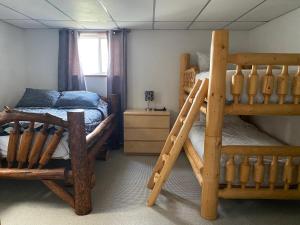a bedroom with two bunk beds and a bed at 316 Patricia Street Accommodation in Jasper