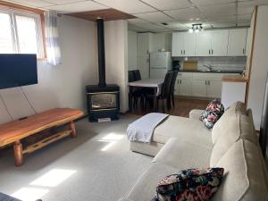 a living room with a couch and a stove at 316 Patricia Street Accommodation in Jasper