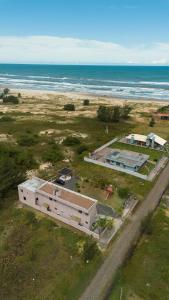 Bella Praia apartamento Estrela do mar في باسو دي توريس: اطلالة جوية على مبنى مجاور للمحيط