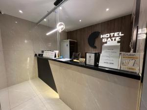 a hotel counter with a hotel cafe sign on the wall at Hotel Gate in Incheon