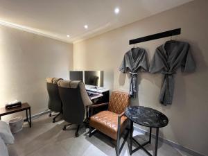 a dressing room with a desk and chairs and a table at Hotel Gate in Incheon