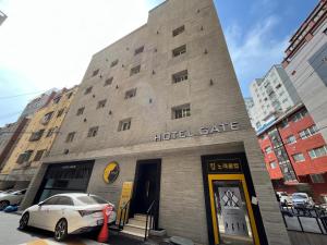 a hotel building with a car parked in front of it at Hotel Gate in Incheon