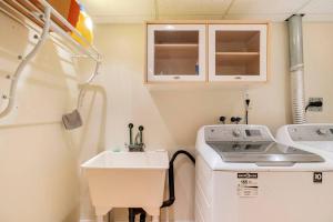 a small bathroom with a sink and a washing machine at Cozy basement apartment in Newmarket in Newmarket +13 photos