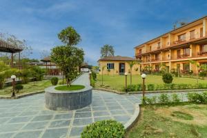 a building with a tree in the middle of a courtyard at Sisai Park Village in Chitwan