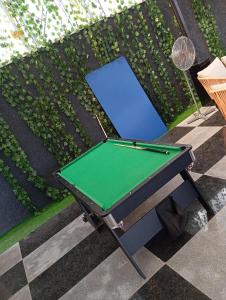 a ping pong table in front of a garden at 3 Bedroom Luxury Duplex (terrace) in Enugu