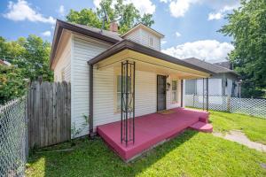a small house with a pink bench in the yard at Affordable, Quaint Retreat! 5 Mins to Downtown in Indianapolis