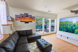 a living room with a couch and a large screen tv at Closer to Northern Quest Casino, Fairchild AFB Spokane Intl Airport Indian Canyon and Sacred Heart Hospital in Spokane