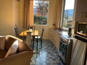 a kitchen with a table and a dining room at Alpine Springs Motel in Hanmer Springs