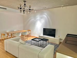 a living room with a couch and a table at ZHome - HaiQi Garden - Four Bedroom Apartment on the Bund with Bund View in Shanghai