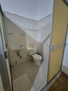 a small bathroom with a toilet and a sink at Casa a pasos del corazón de Zapatoca in Zapatoca