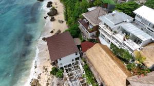 an aerial view of a house and the beach at Archie Home in Uluwatu