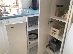 a kitchen with a sink and a kitchen pantry at Maggie's Nest-Come & Rest in Killarney Vale