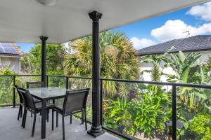 a patio with a table and chairs on a balcony at Byron Bay Accom Unit 3 5-9 Somerset Street - Summer Central in Byron Bay