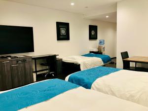Postel nebo postele na pokoji v ubytování Hotel Square FujiGotemba