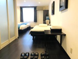 Postel nebo postele na pokoji v ubytování Hotel Square FujiGotemba