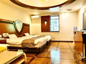 Postel nebo postele na pokoji v ubytování Hotel Square FujiGotemba