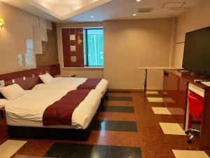 Postel nebo postele na pokoji v ubytování Hotel Square FujiGotemba