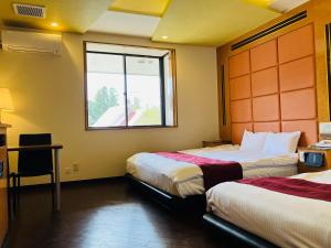 Postel nebo postele na pokoji v ubytování Hotel Square FujiGotemba