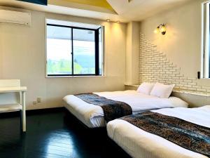 Postel nebo postele na pokoji v ubytování Hotel Square FujiGotemba