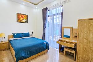 a bedroom with a bed and a dresser and a mirror at Mai DiaMond Hotel in Da Lat