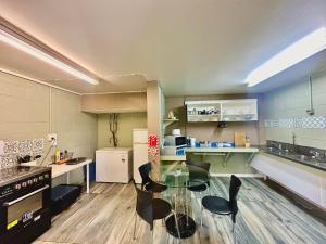 a kitchen with a glass table and chairs in it at Haruru Falls Motel & Conference Centre in Paihia