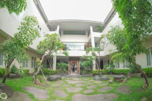 an exterior view of a building with trees at Bale Ocasa in Tangerang