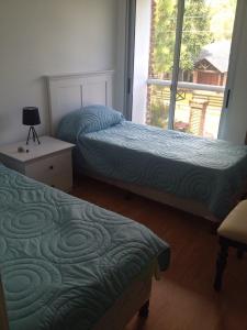 Łóżko lub łóżka w pokoju w obiekcie Apartamento En Las Delicias