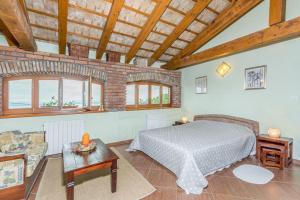 a bedroom with a bed and a brick wall at The Shire in Poljane