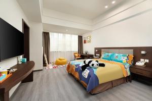 a bedroom with a panda bear on a bed at Holiday Inn Express Chengdu Wuhou by IHG-Wuhou Temple and Jinli in Chengdu