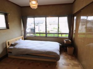 Postel nebo postele na pokoji v ubytování Shionome house