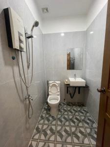 a bathroom with a toilet and a sink at HOLY VILLA 4rooms, 5beds, 6baths, 1KCH, 1LR riverside private villa in Kampot