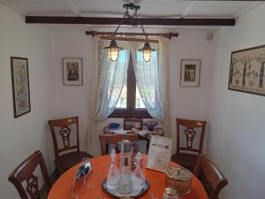 a dining room with a table and a window at Villa Ampelia in Sitia