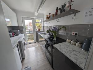a kitchen with a counter top and a stove top oven at Walkers haven in Canterbury