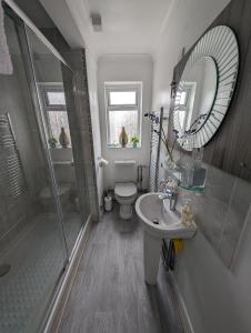 a bathroom with a shower toilet and a sink at Walkers haven in Canterbury