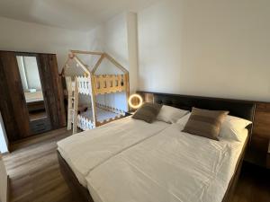 a bedroom with a large bed and a staircase at Srbská Kamenice 22 in Srbská Kamenice